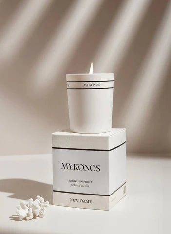 White Mykonos scented candle on its box with coral decor, luxury fragrance gift